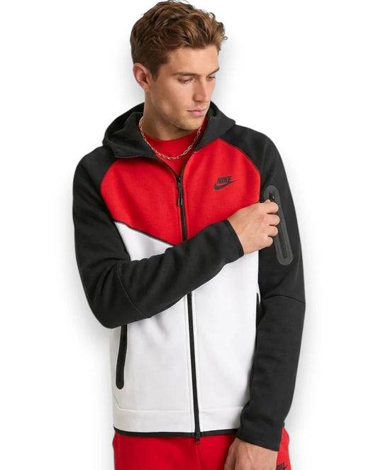Man wearing a Nike tracksuit with a red, black, and white design on a white background